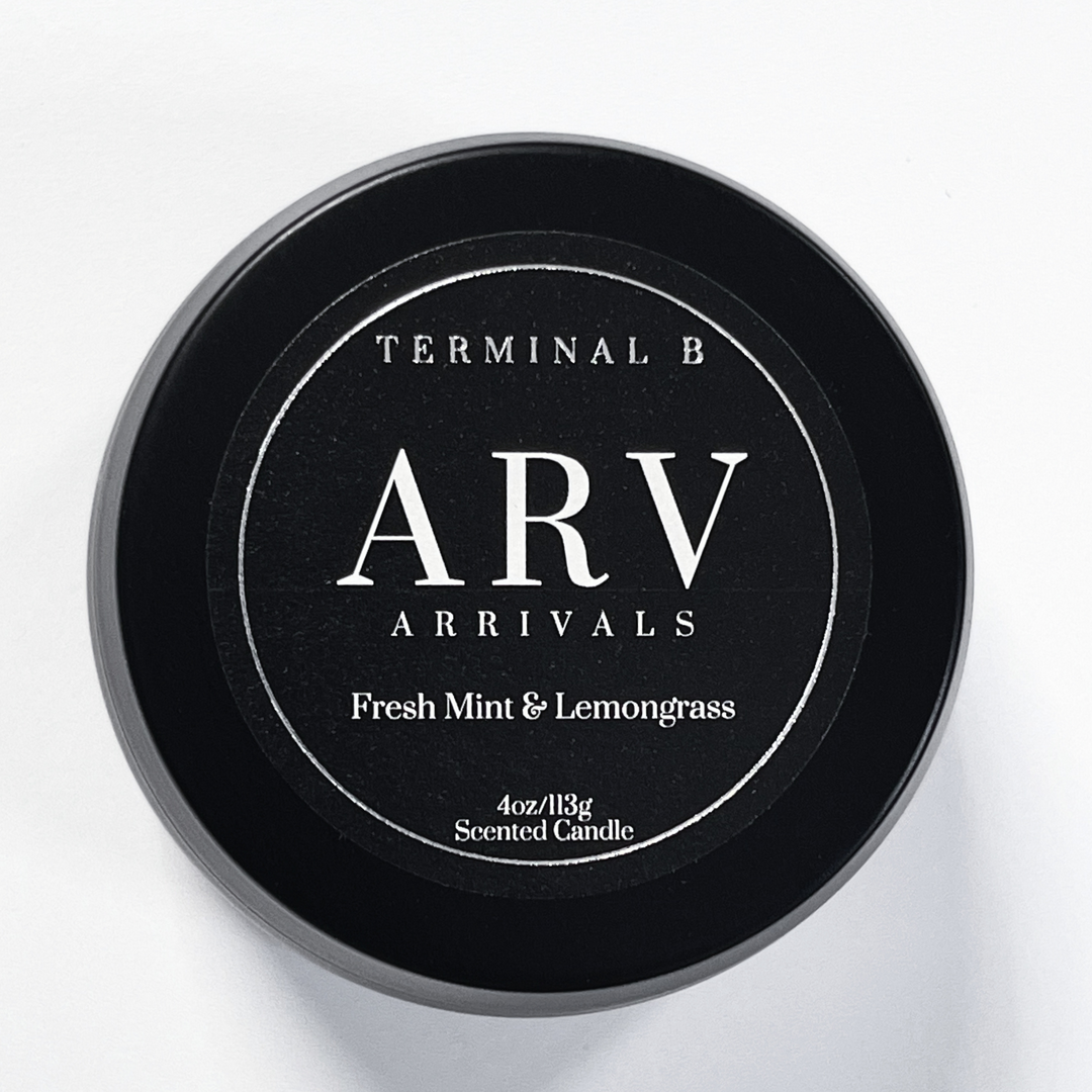 ARV-Arrivals 4oz Travel Tin candle by Terminal B. Fresh Mint & Lemongrass fragranced and displayed against a white background. Carefully designed for an elegant, long-lasting scent.