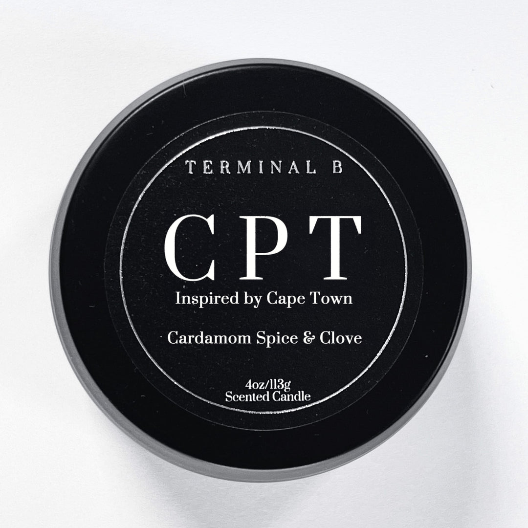 CPT 4oz Travel Tin candle by Terminal B. Cardamom Spice & Clove fragranced and displayed against a white background. Inspired by Cape Town, carefully designed for an elegant, long-lasting scent.