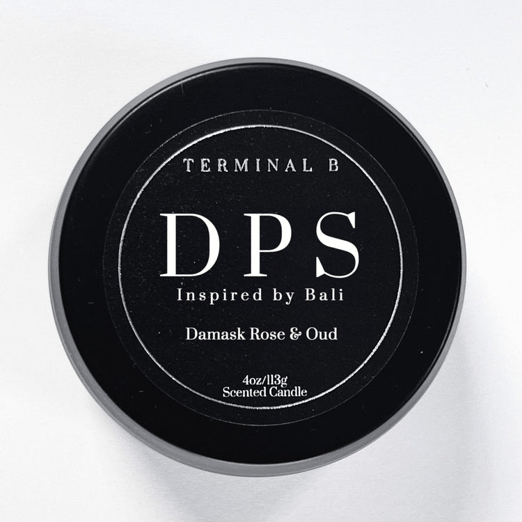 DPS 4oz Travel Tin candle by Terminal B. Damask Rose & Oud fragranced and displayed against a white background. Inspired by Bali, carefully designed for an elegant, long-lasting scent.