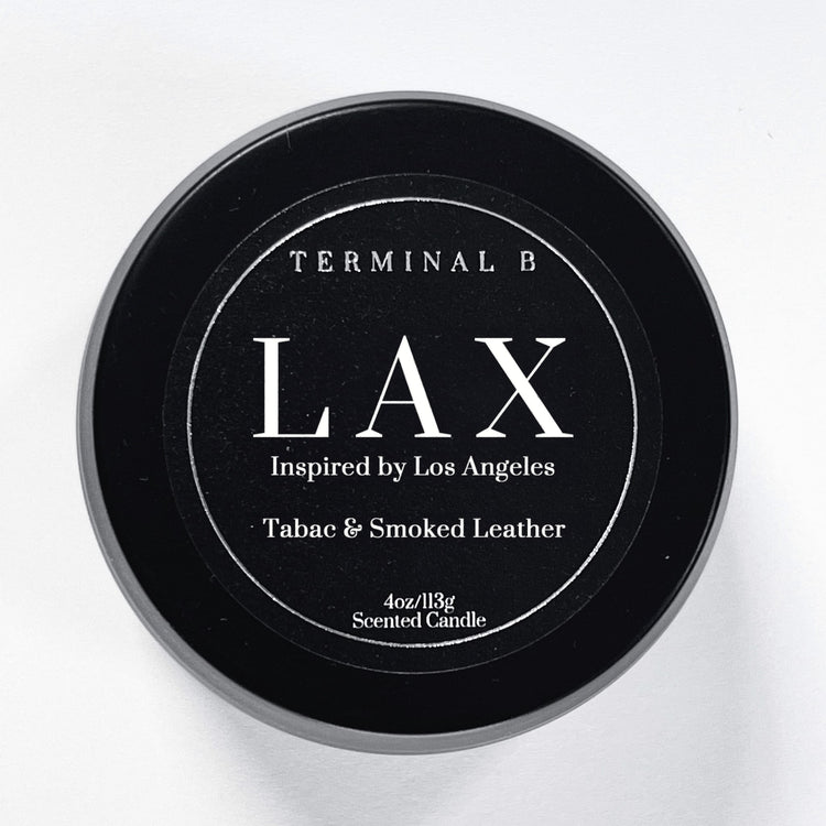 LAX 4oz Travel Tin candle by Terminal B. Tabac & Smoked Leather fragranced and displayed against a white background. Inspired by Los Angeles, carefully designed for an elegant, long-lasting scent.