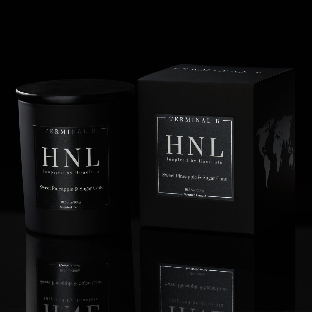 HNL luxury candle by Terminal B in Sweet Pineapple & Sugar Cane fragrance, displayed against a black background. Inspired by Honolulu, carefully designed for an elegant, long-lasting scent.