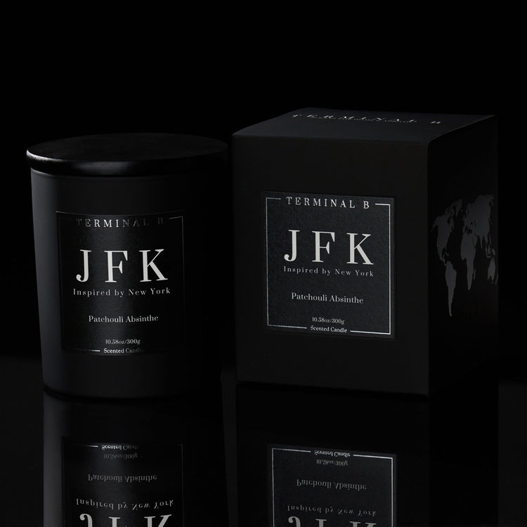 JFK luxury candle by Terminal B in Patchouli Absinthe fragrance, displayed against a black background. Inspired by New York, carefully designed for an elegant, long-lasting scent.